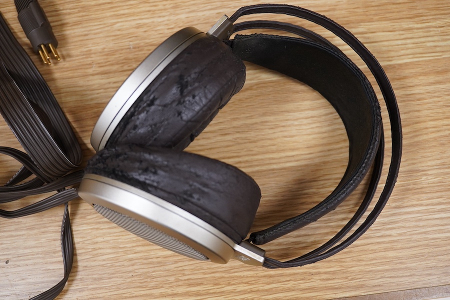 A pair of over-ear Japanese Stax Electrostatic earspeakers, SR-009S, contained within the original wooden box, with outer packaging, owners manual, etc. together with the Stax driver unit for earspeakers with vacuum tube